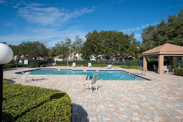 view of swimming pool featuring a gazebo and a patio