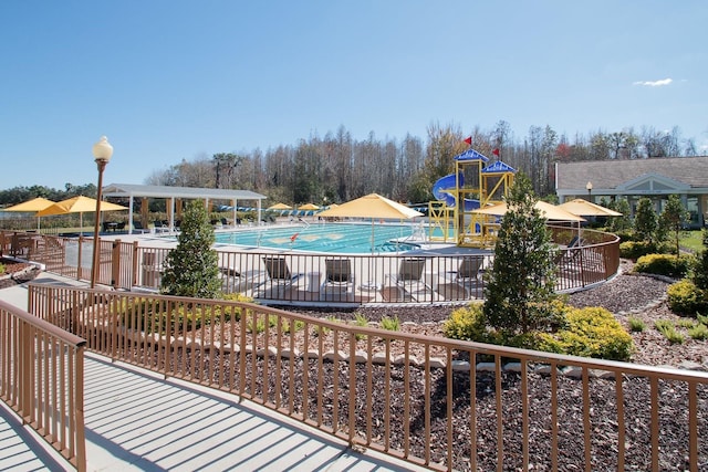 view of pool with a playground