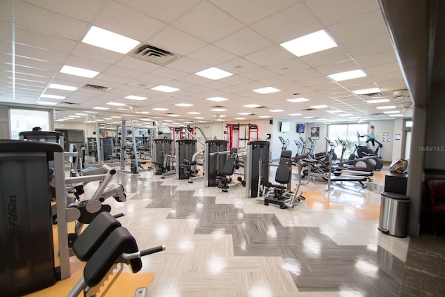 workout area featuring a paneled ceiling