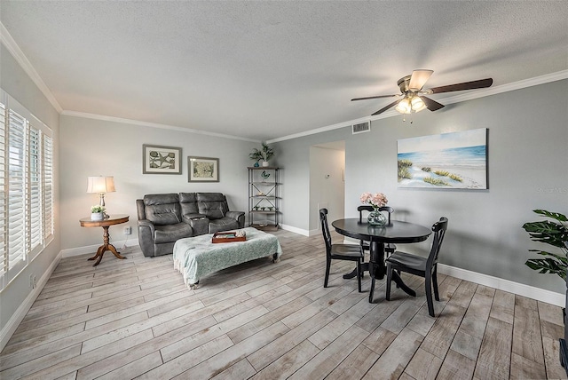 dining space featuring plenty of natural light, ornamental molding, and ceiling fan