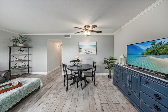 dining area featuring ceiling fan, crown molding, light hardwood / wood-style floors, and a textured ceiling