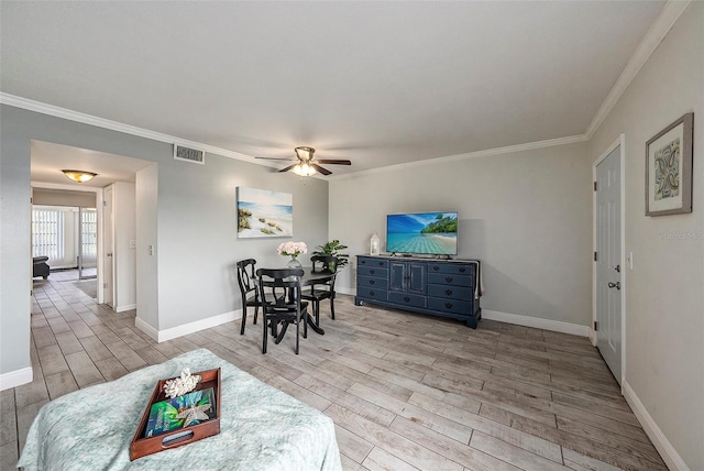 dining space with ceiling fan, crown molding, and light wood-type flooring