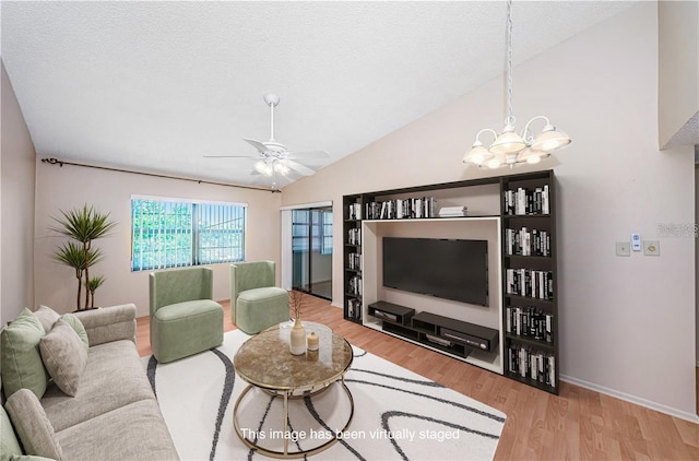 living room with a textured ceiling, hardwood / wood-style floors, ceiling fan with notable chandelier, and lofted ceiling