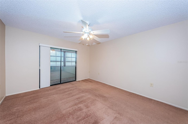 empty room with light carpet, ceiling fan, and a textured ceiling