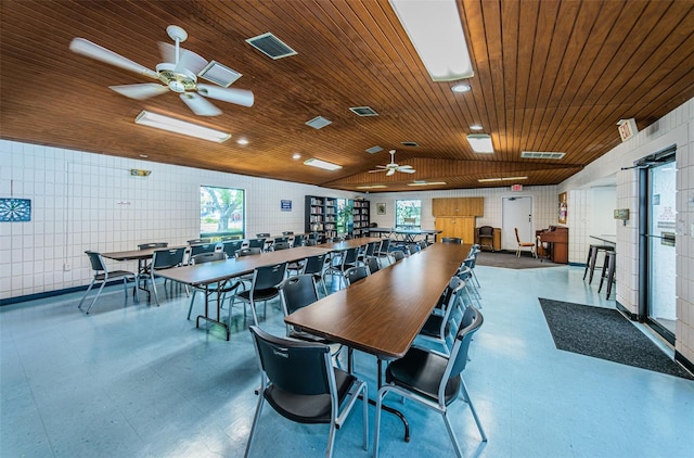 dining room with tile walls, ceiling fan, wooden ceiling, and vaulted ceiling