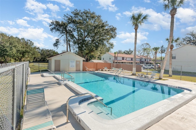 view of swimming pool with a patio area and an outbuilding