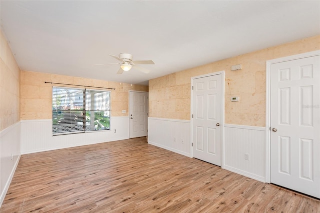 unfurnished room featuring ceiling fan and light wood-type flooring