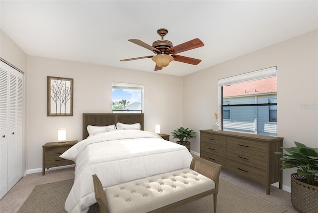 carpeted bedroom with ceiling fan and a closet