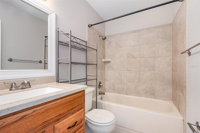 full bathroom with vanity, tiled shower / bath combo, and toilet