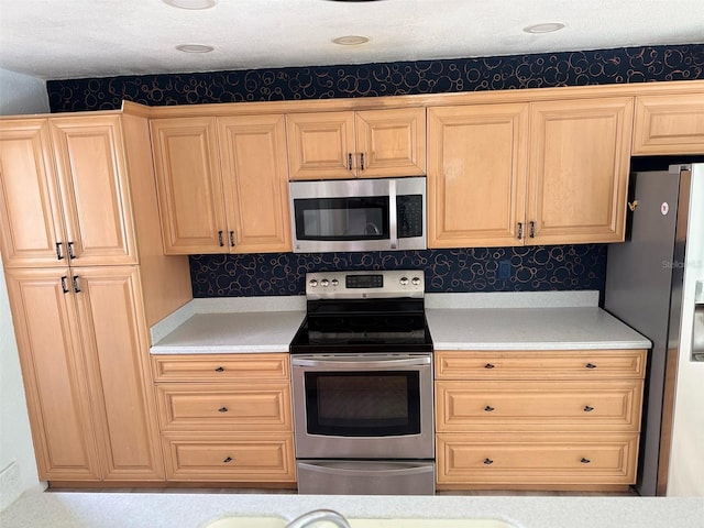 kitchen with stainless steel appliances, light brown cabinetry, and tasteful backsplash