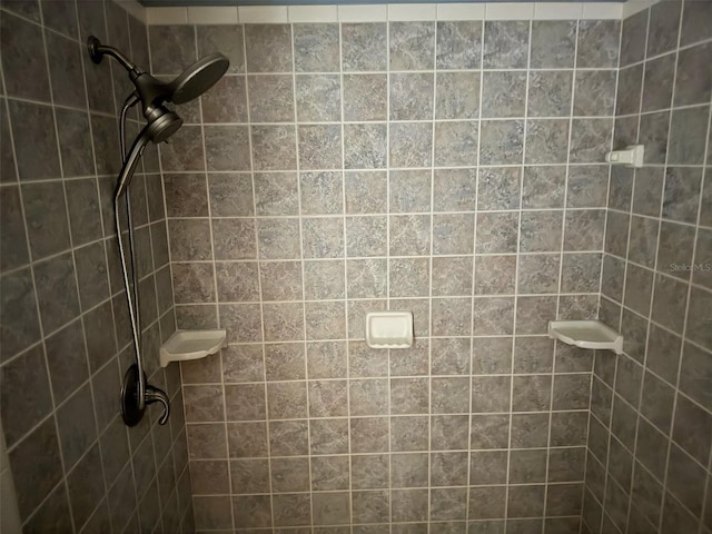 bathroom with a tile shower