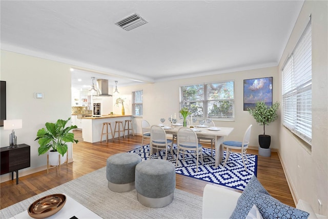 living room featuring hardwood / wood-style flooring and crown molding