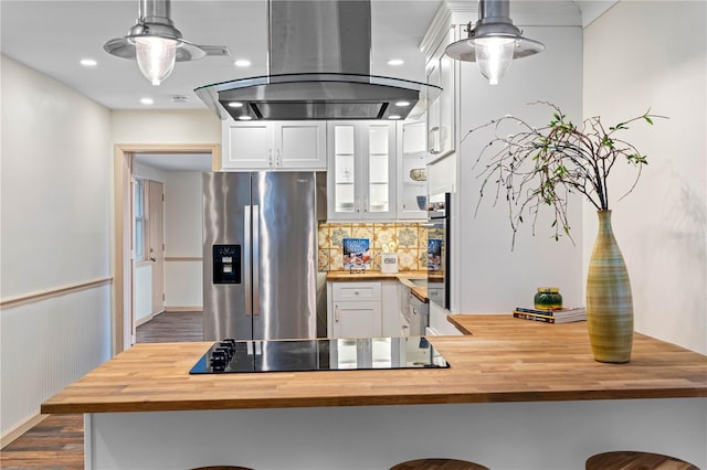 kitchen with island range hood, stainless steel refrigerator with ice dispenser, and wood counters