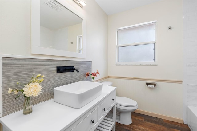 full bathroom with shower / bathing tub combination, hardwood / wood-style floors, vanity, and toilet