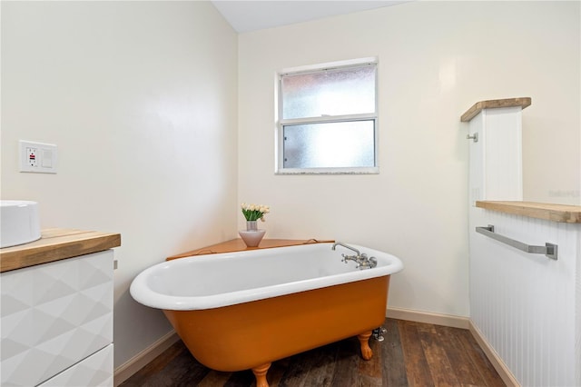 bathroom featuring a tub to relax in and hardwood / wood-style flooring