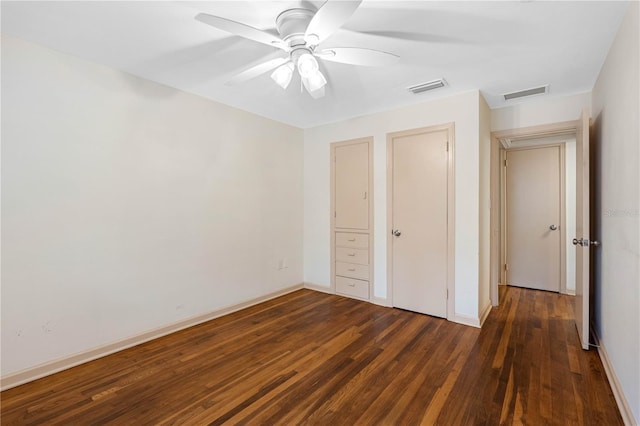 unfurnished bedroom with dark hardwood / wood-style flooring and ceiling fan