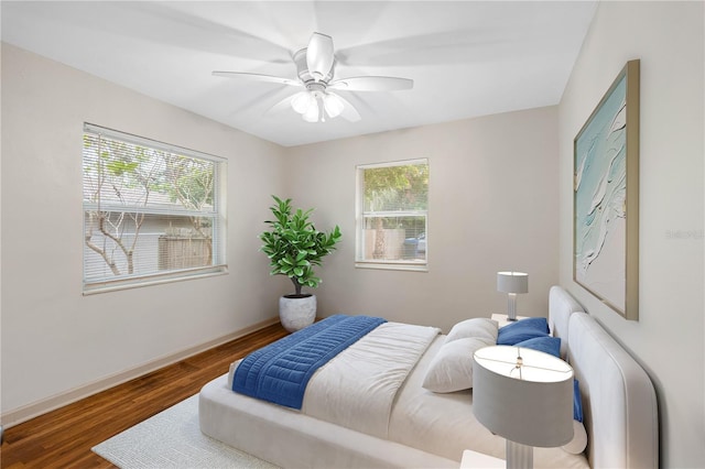 bedroom with ceiling fan and dark hardwood / wood-style floors