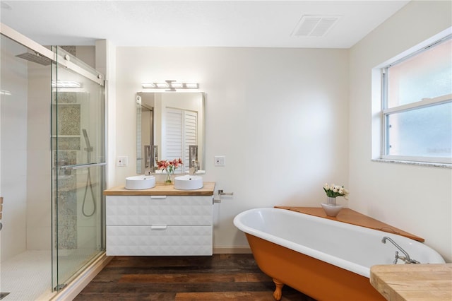 bathroom with hardwood / wood-style flooring, vanity, and shower with separate bathtub