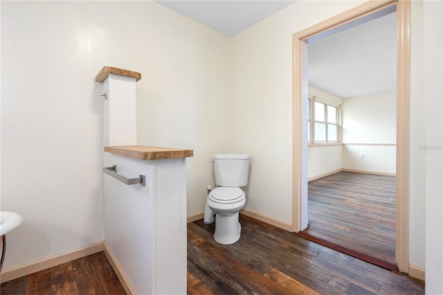 bathroom featuring toilet and wood-type flooring