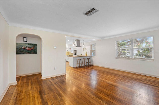 unfurnished living room with dark hardwood / wood-style floors