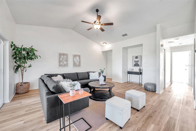 living room featuring ceiling fan, light hardwood / wood-style flooring, and lofted ceiling