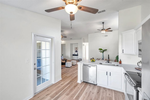 kitchen featuring sink, light hardwood / wood-style flooring, appliances with stainless steel finishes, white cabinetry, and kitchen peninsula