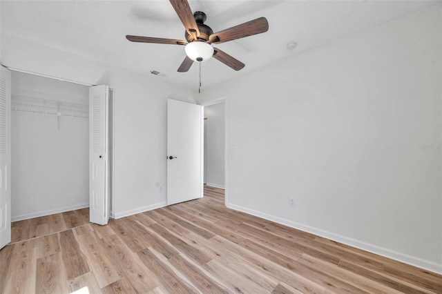 unfurnished bedroom with ceiling fan, a closet, and light hardwood / wood-style flooring