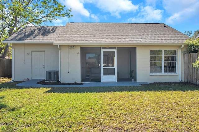 rear view of property featuring a yard, cooling unit, and a sunroom