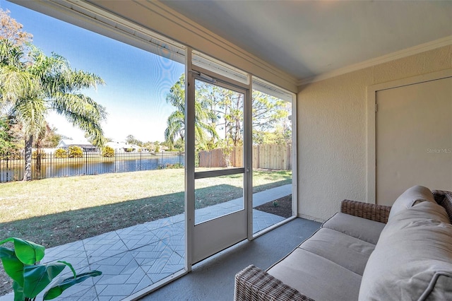 sunroom / solarium with a water view