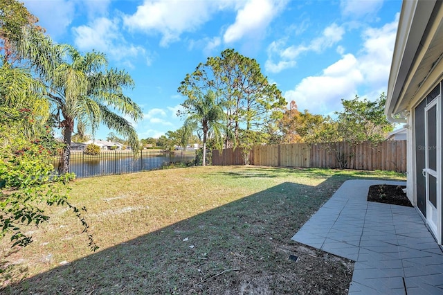 view of yard featuring a patio and a water view