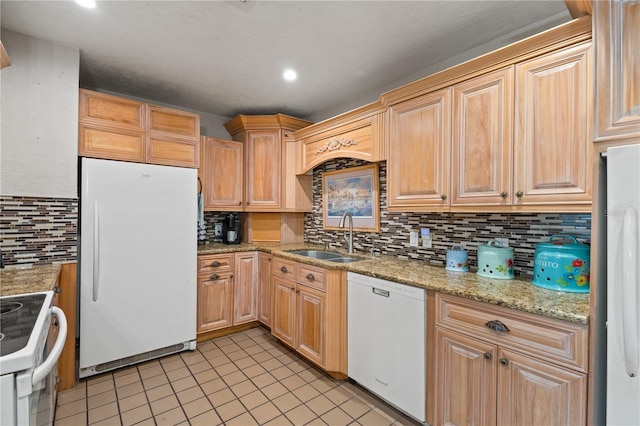 kitchen with white appliances, sink, decorative backsplash, light stone countertops, and light tile patterned floors