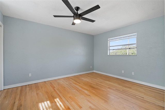 spare room with ceiling fan and light wood-type flooring