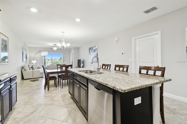 kitchen featuring a kitchen breakfast bar, dishwasher, a center island with sink, and sink