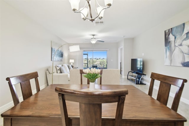 dining area with ceiling fan with notable chandelier