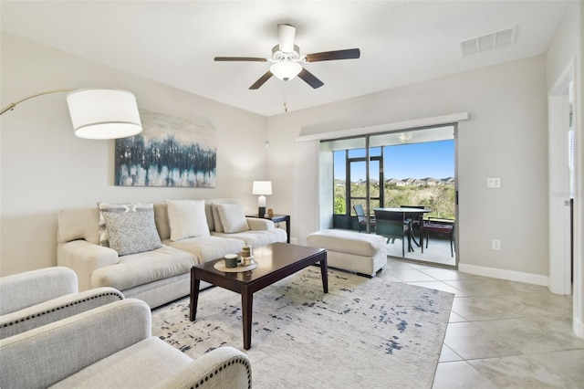 tiled living room featuring ceiling fan