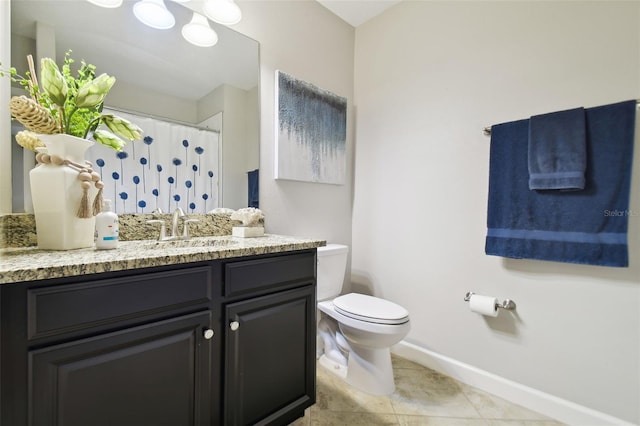 bathroom featuring tile patterned floors, vanity, and toilet