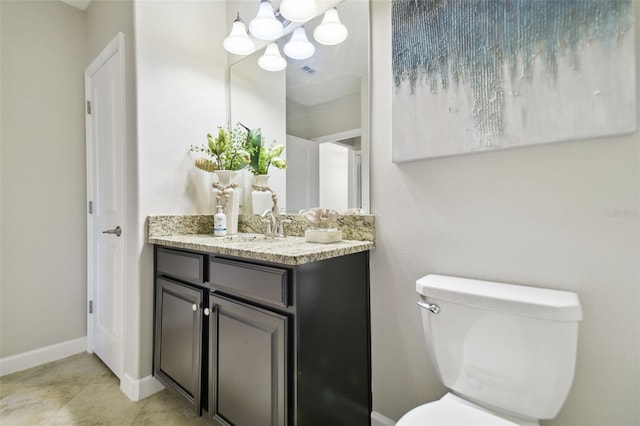 bathroom featuring vanity, a chandelier, and toilet