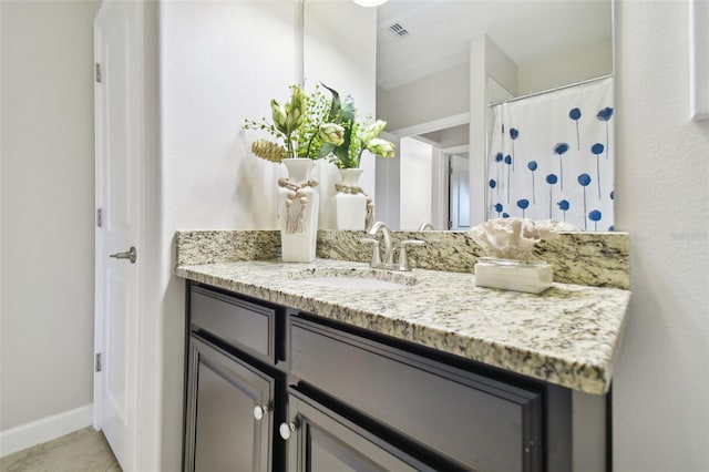 bathroom with tile patterned flooring and vanity