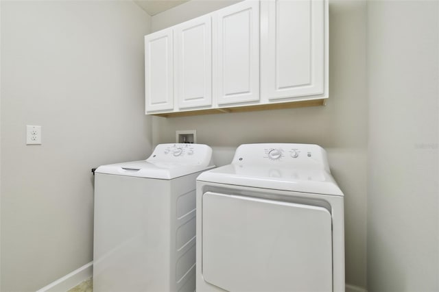 washroom with cabinets and washing machine and dryer