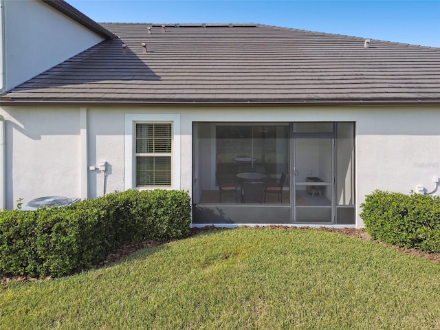 rear view of property with a yard