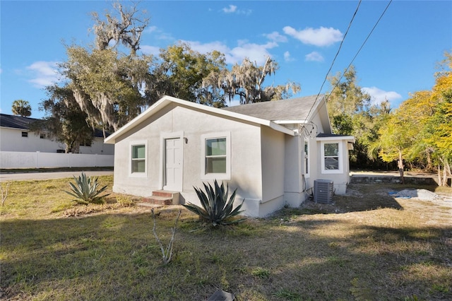 exterior space with a front yard and central AC