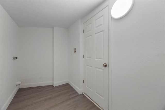 laundry room with electric dryer hookup and light hardwood / wood-style floors