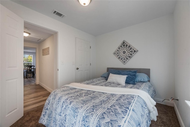 bedroom with dark colored carpet