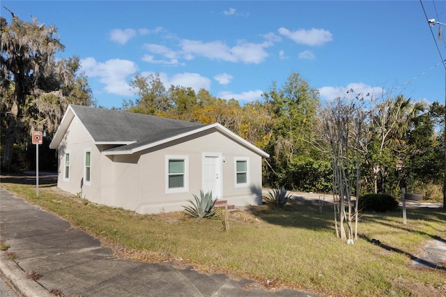 view of side of property with a lawn