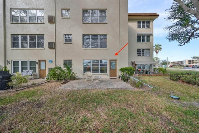 rear view of property with a patio area and a yard