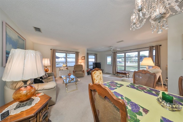 interior space with plenty of natural light, ceiling fan, and a textured ceiling