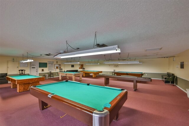 game room with carpet flooring, a textured ceiling, and pool table