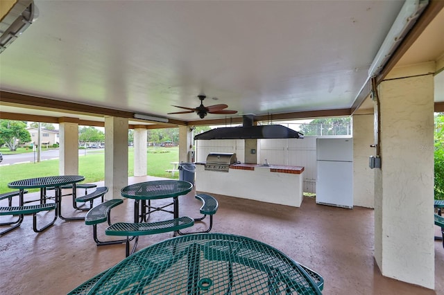 view of patio / terrace with ceiling fan, grilling area, and exterior kitchen