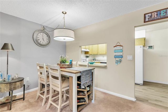 dining space with a textured ceiling