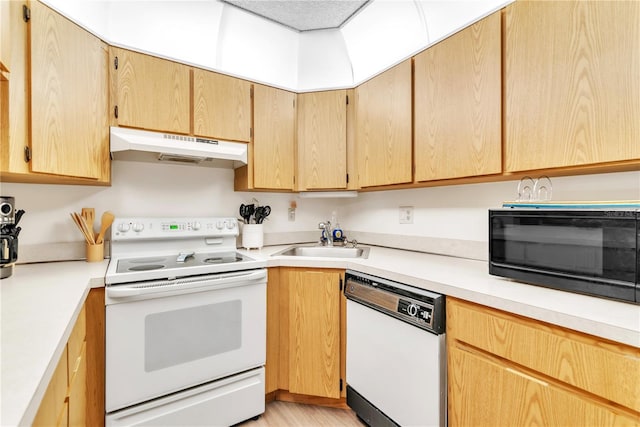 kitchen featuring light brown cabinets, white appliances, and sink